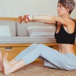 Elderly woman in a yoga pose indoors, embracing healthy lifestyle and wellness.